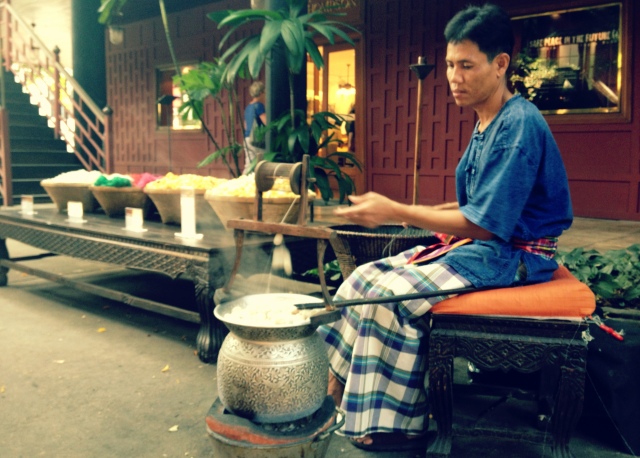 A local Thai man spins pure silk at the Jim Thompson house.